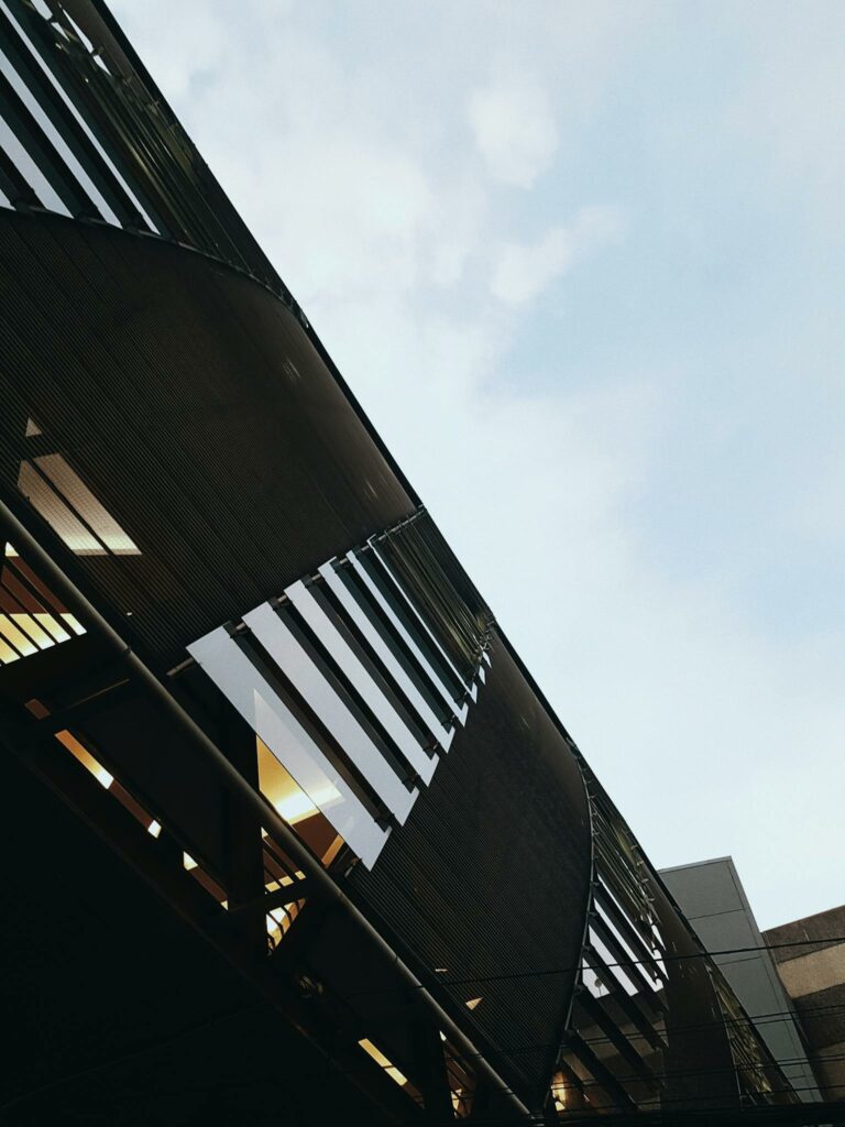 Low angle of contemporary office building with concrete and glass mirrored walls located in business district